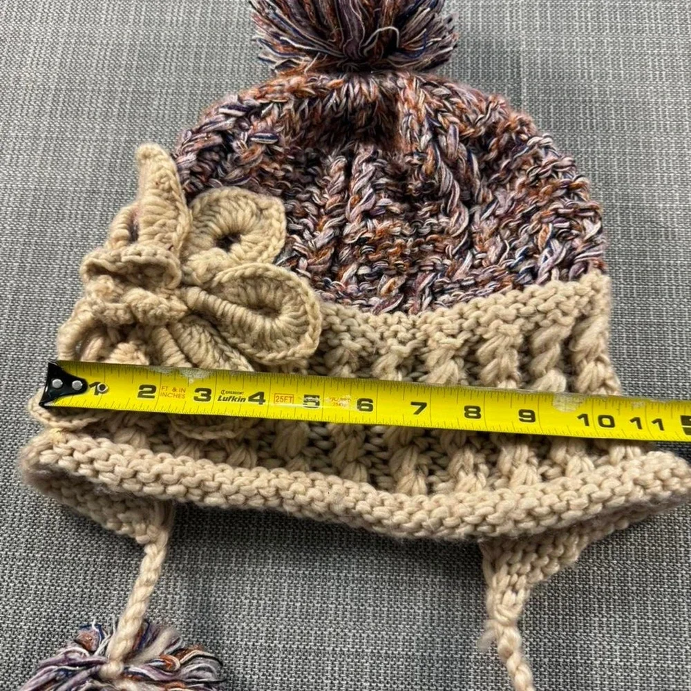 Multicolored knitted hat with pom poms
